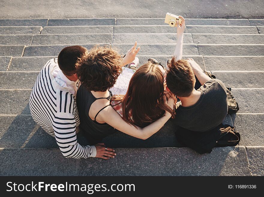 Friendship, togetherness, youth, holidays. Group of friends taking selfie at camera in city