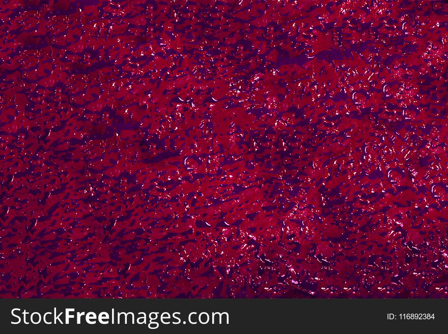 Background of purple sprouts on red paper.