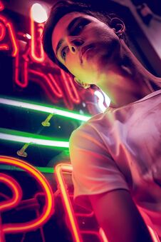 Young Man, Lit By Neon Light At Night. Stock Photos