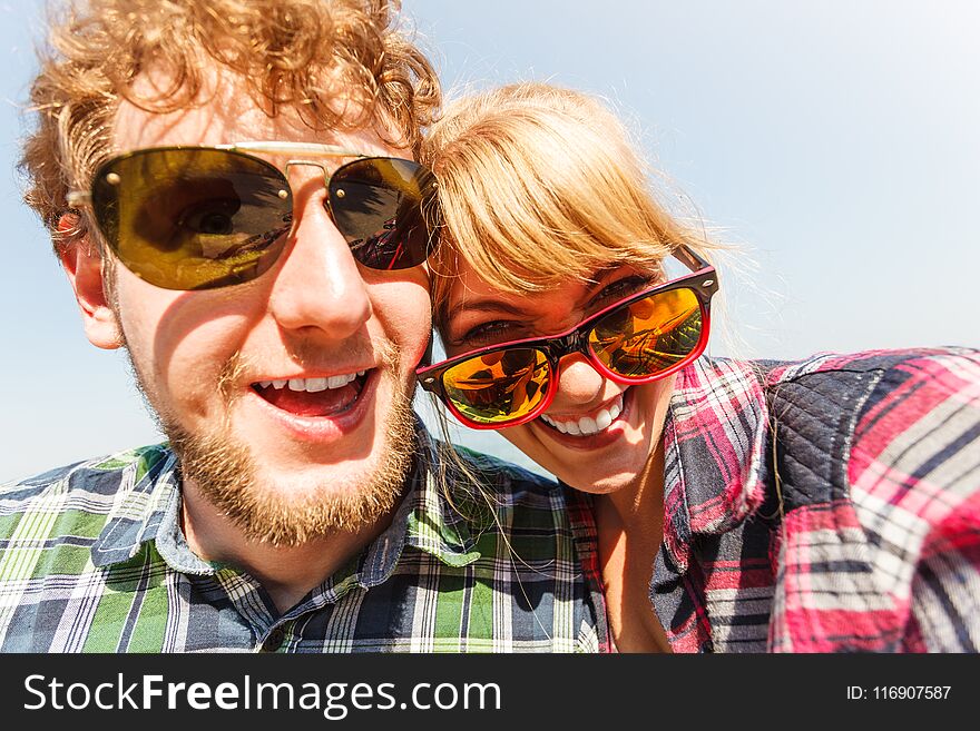 Happy smiling young couple outdoor. Pretty attractive women and handsome men in sunglasses. Happy smiling young couple outdoor. Pretty attractive women and handsome men in sunglasses.