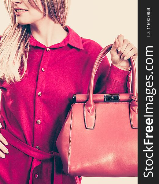 Fashionable pretty young woman wearing elegant casual red shirt and holding leather bag presenting stylish outfit. Fashionable pretty young woman wearing elegant casual red shirt and holding leather bag presenting stylish outfit.