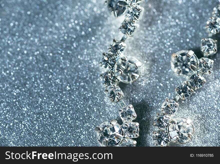 Silver Jewelry With Diamonds Close-up On A Gray Shiny Background