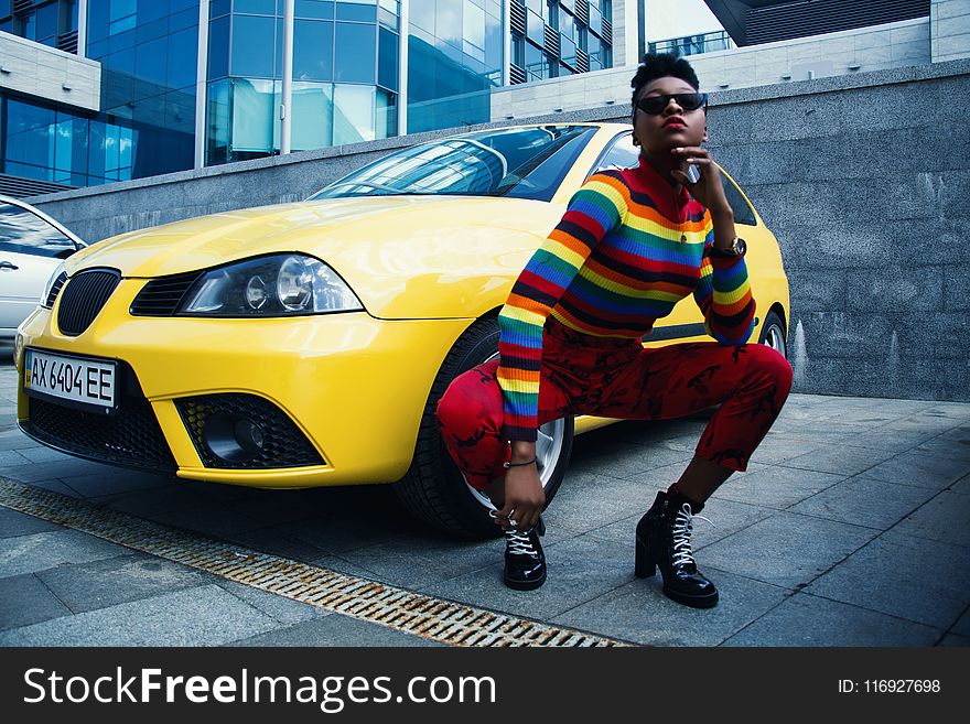 Woman Wearing Red Leggings Beside Yellow Car