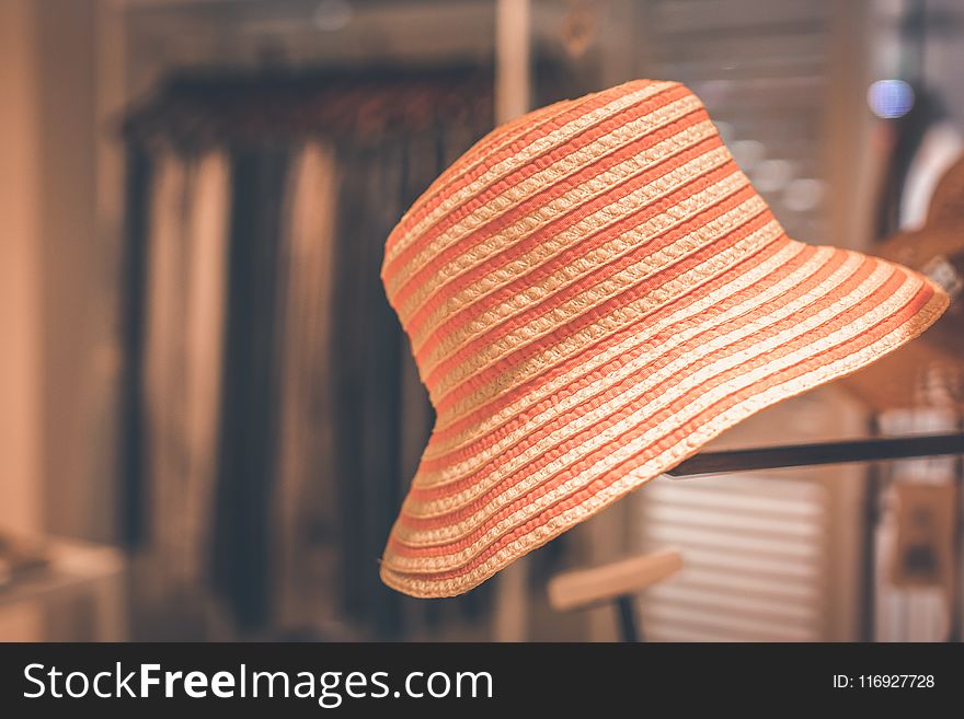 Selective Focus Photography of Orange Hat