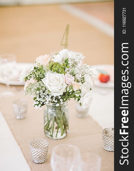 White Flowers on Clear Glass Mason Jar