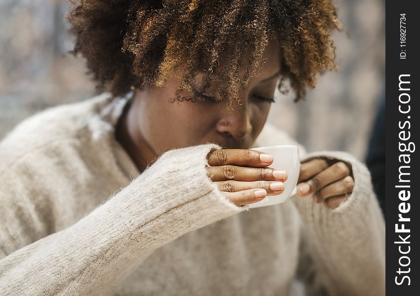 Woman Holding A Cup While Drinking