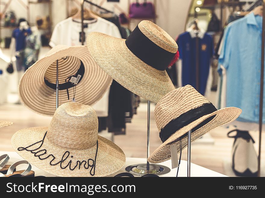 Four Brown Straw Hats Display