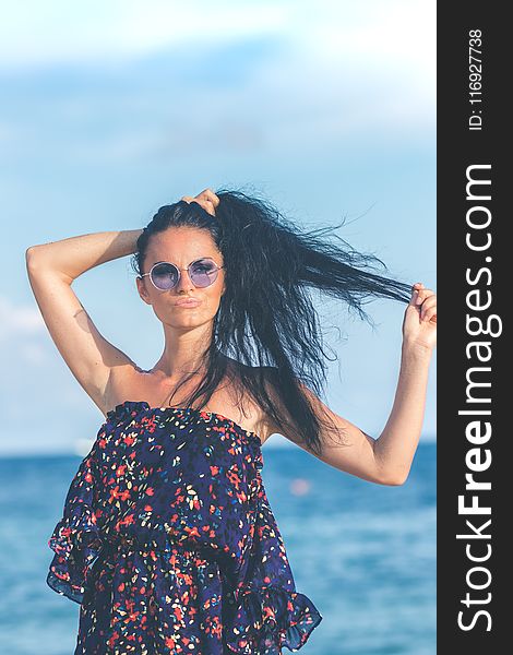 Woman in Blue Dress Standing Near Body of Water