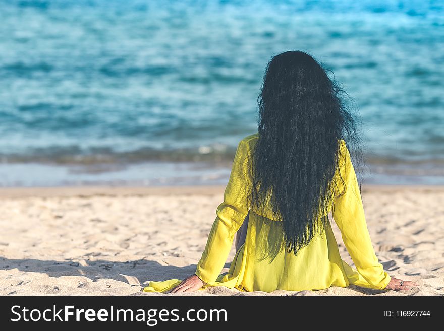 Woman Sitting Near Ocean