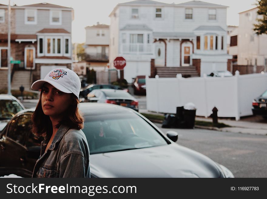 Shallow Focus Photography of Woman in Gray Denim Jacket Standing Near Car