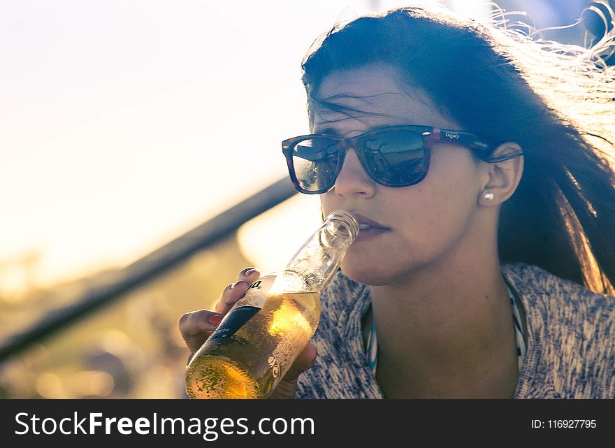 Woman Drinking Beverage on Bottle