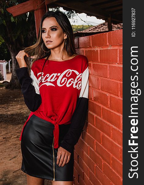Woman Wearing Black, White, and Red Coca-cola Long-sleeved Shirt and Mini Skirt