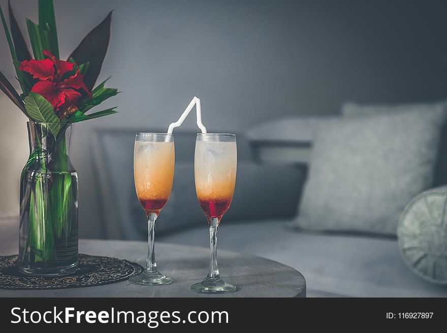 Two Clear Wine Glasses Filled With Red Liquids