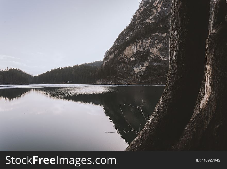 Landscape Photography of Lake Beside Cliff at Daytime