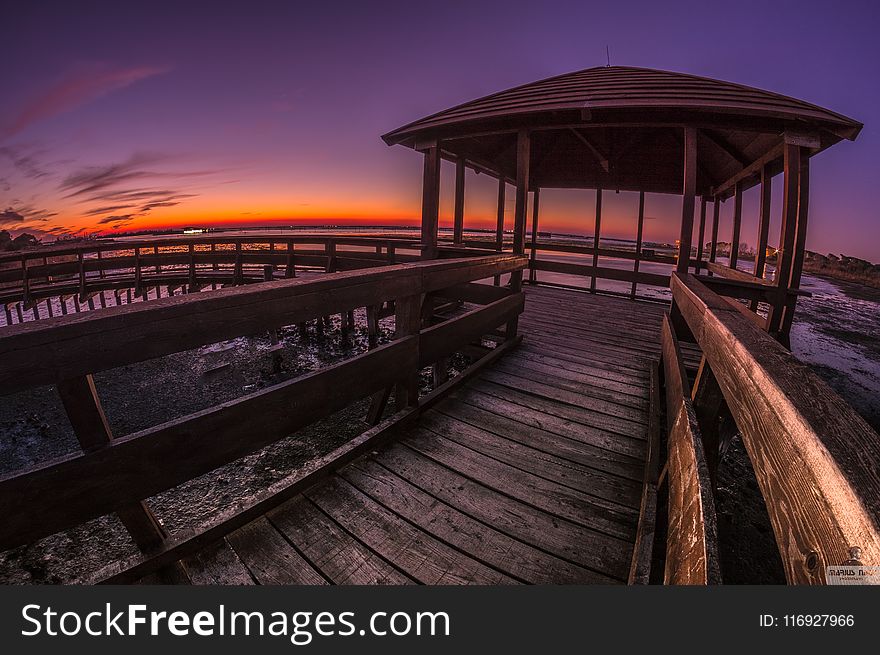 Brown Wooden Pagoda Under Golden Sky