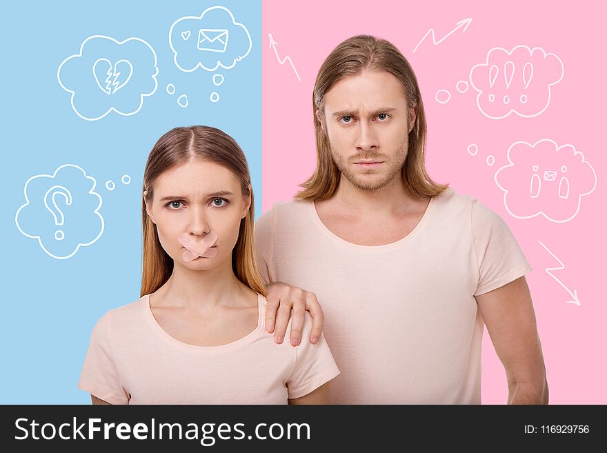 Pregnancy. Young pregnant women standing with a sticking plaster on the mouth and her serious calm husband putting his hand on her shoulder. Pregnancy. Young pregnant women standing with a sticking plaster on the mouth and her serious calm husband putting his hand on her shoulder