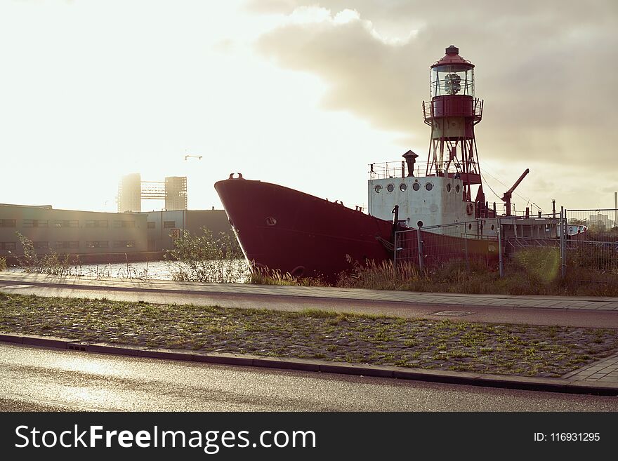 A docked red cargo ship in an industrail estate in NDSM Amsterdam. A docked red cargo ship in an industrail estate in NDSM Amsterdam.