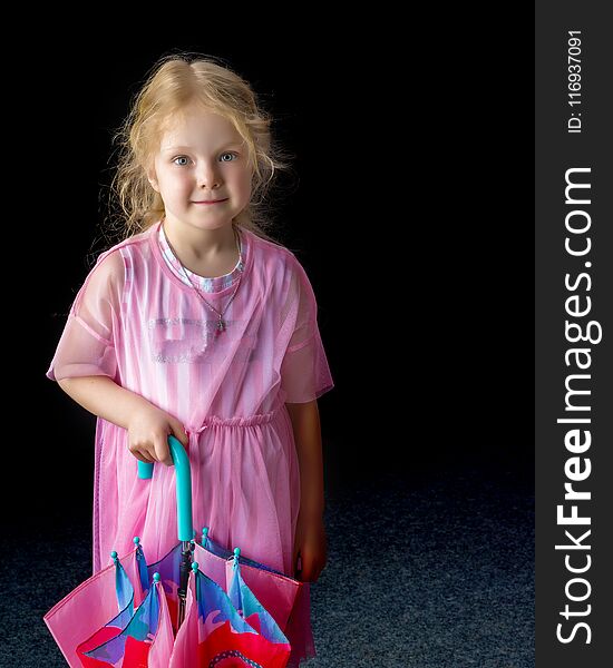 A nice little girl with an umbrella on a black background. A nice little girl with an umbrella on a black background.