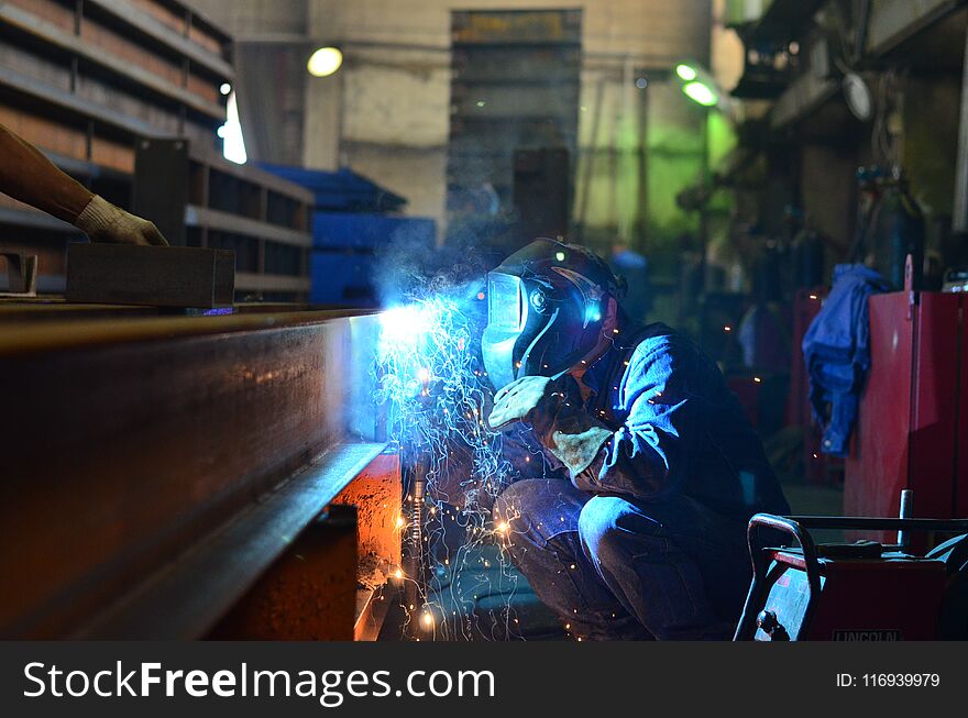 Welders work at the factory creating metal structures for industrial equipment