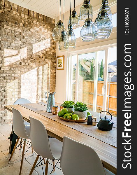 Black Kettle Beside Condiment Shakers and Green Fruits and Plants on Tray on Brown Wooden Table