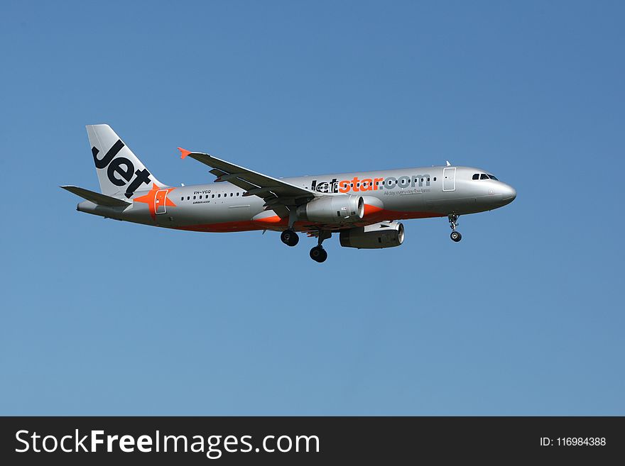 Jetstar Plane Flight Under Blue Sky