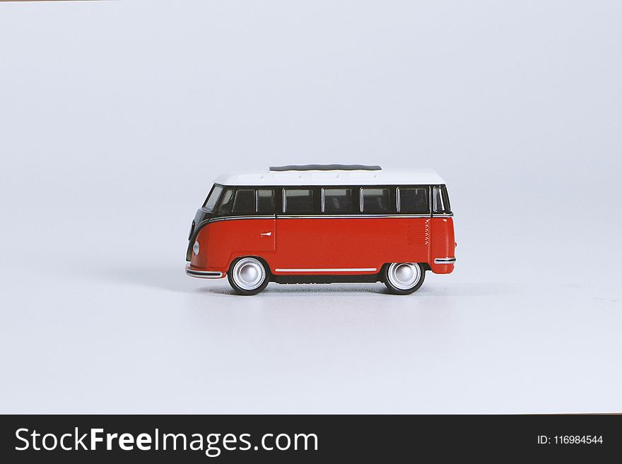 Red Volkswagen T1 Die-cast Toy on White Surface