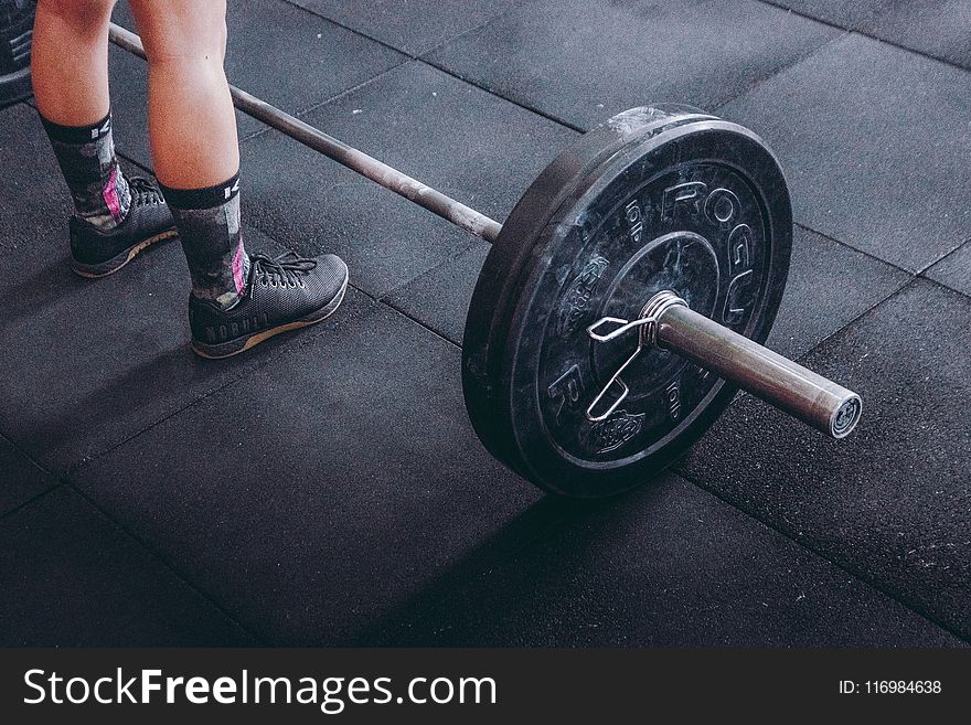 Person Standing Near Black Barbell