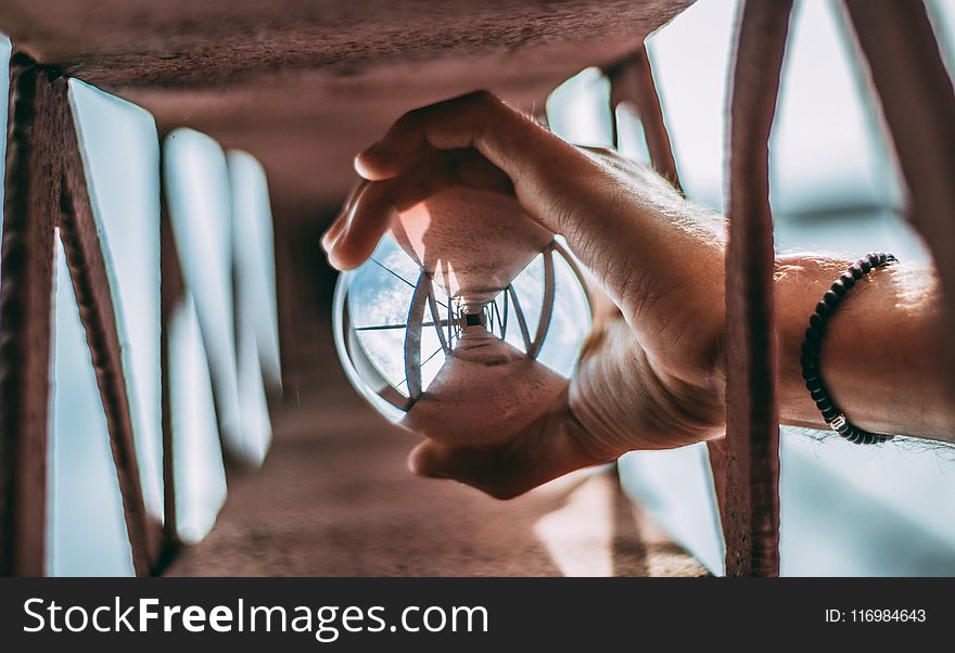 Person Holding Glass Lens