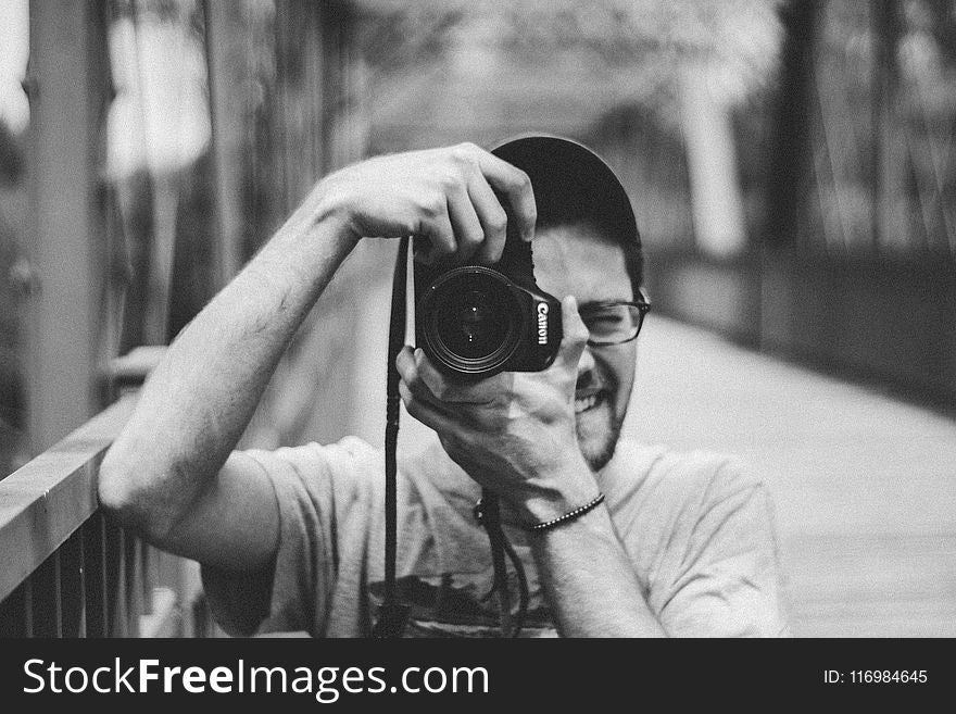 Man Holding Canon Dslr Camera Taking Picture