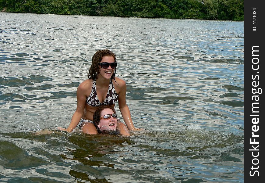 Two best friend sisters having fun in the lake. Two best friend sisters having fun in the lake.