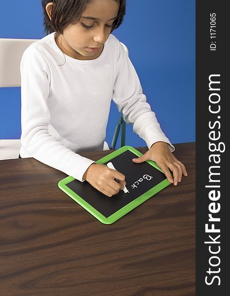 Little girl writing on a board