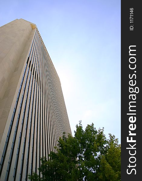 Looking up at an office building against a clear bright sky. Looking up at an office building against a clear bright sky.