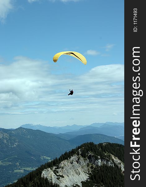 Paraglider flying high over mountains