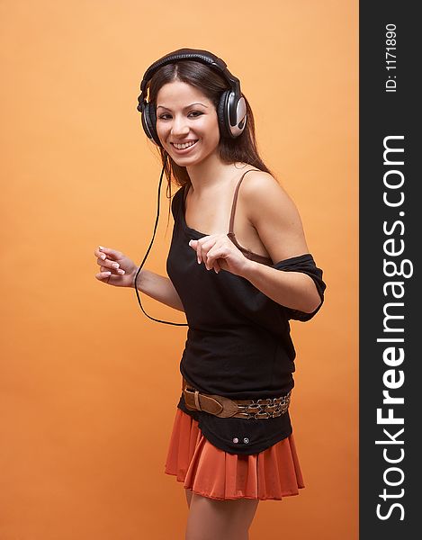 Girl with long dark brown hair, black top, orange miniskirt and headset. Girl with long dark brown hair, black top, orange miniskirt and headset