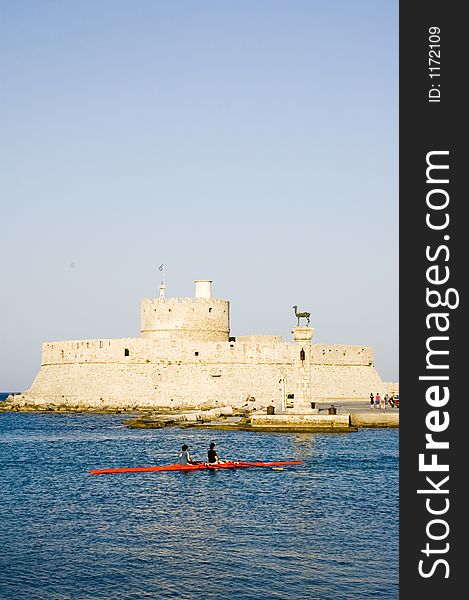 The port of Rhodes with the medieval walls, culum with the city symbol, a deer, and a canoe.