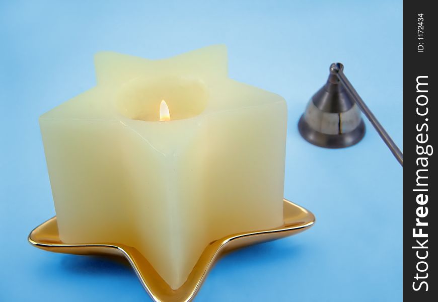 A star shaped candle and snuffer. A star shaped candle and snuffer