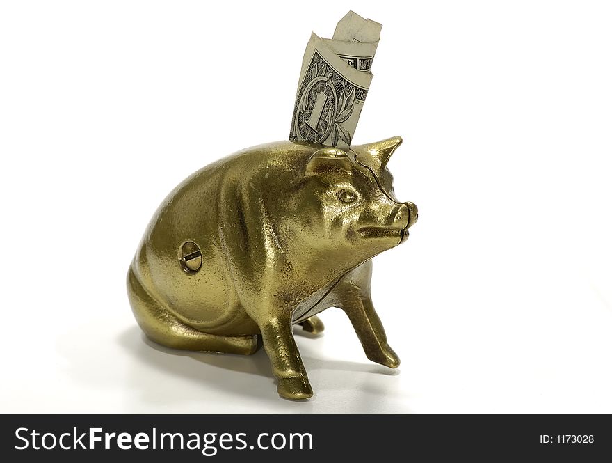 Photo of a Brass Piggy Bank With A Dollar Sticking Out. Photo of a Brass Piggy Bank With A Dollar Sticking Out