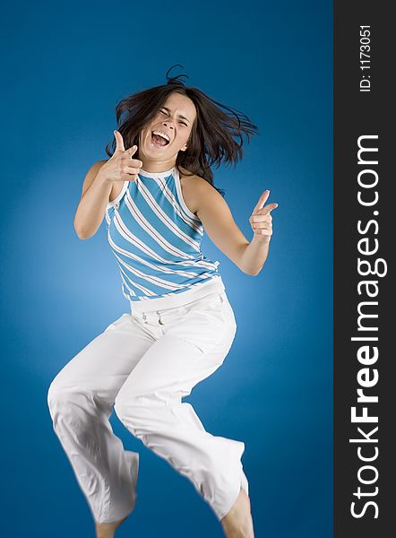 Jumping happy woman on the blue background