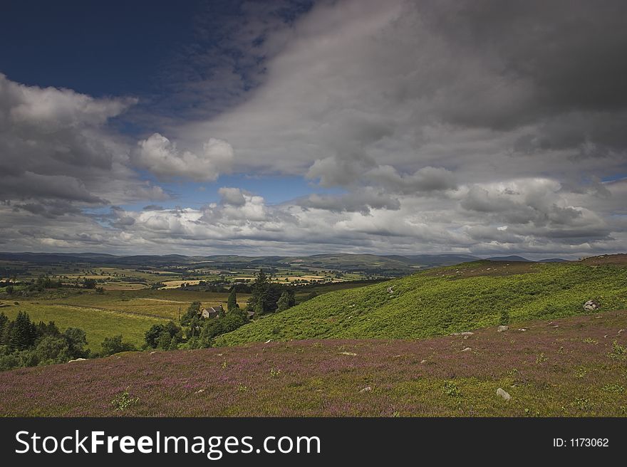 View from moorland over farmland and hills. View from moorland over farmland and hills