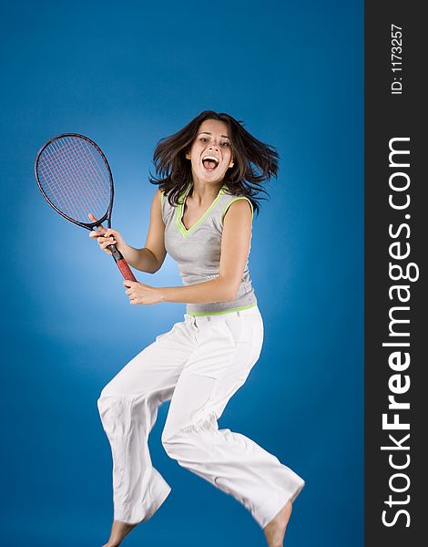 Happy woman with tennis racket on the blue background