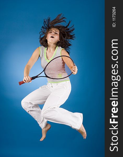 Happy woman with tennis racket on the blue background