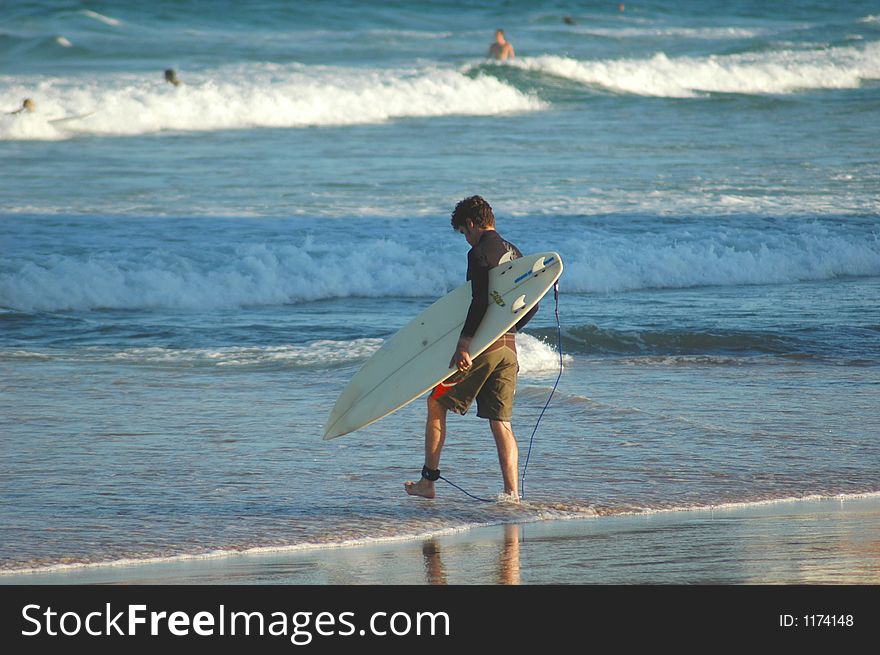 Man walking into the surf. Man walking into the surf