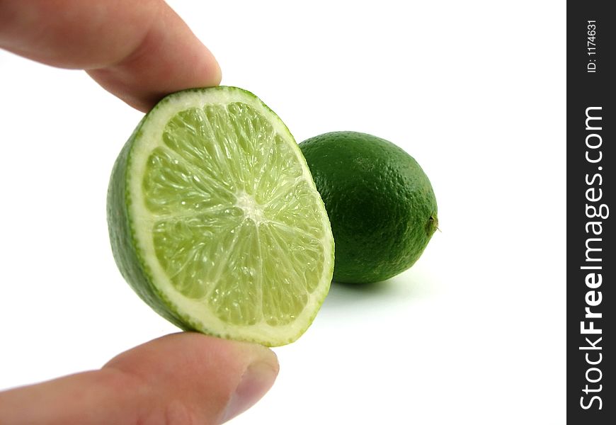 Lime close-up in male hand isolated on white. Lime close-up in male hand isolated on white