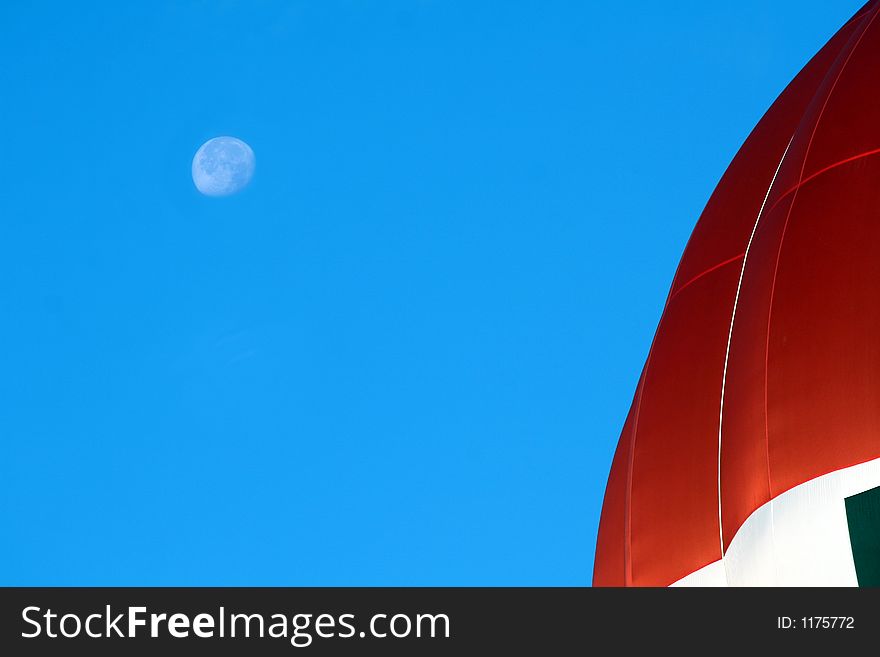 Moon behind a hot air balloon early in the morning. Moon behind a hot air balloon early in the morning