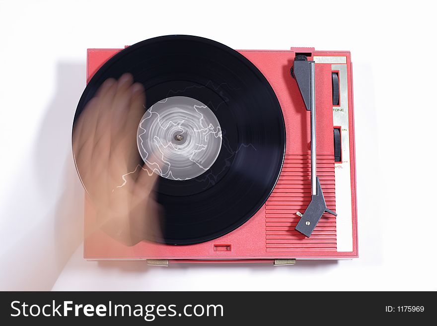 A record on an old red retro record player. A record on an old red retro record player