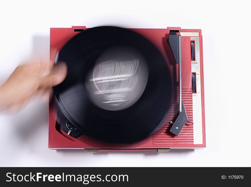 A record on an old red retro record player. A record on an old red retro record player