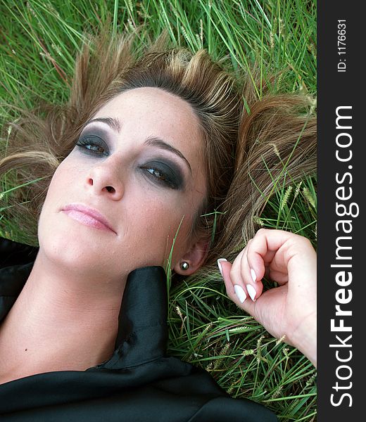 Beautiful woman lying in a green field. Beautiful woman lying in a green field