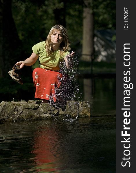 Woman is splashing a water. Woman is splashing a water.