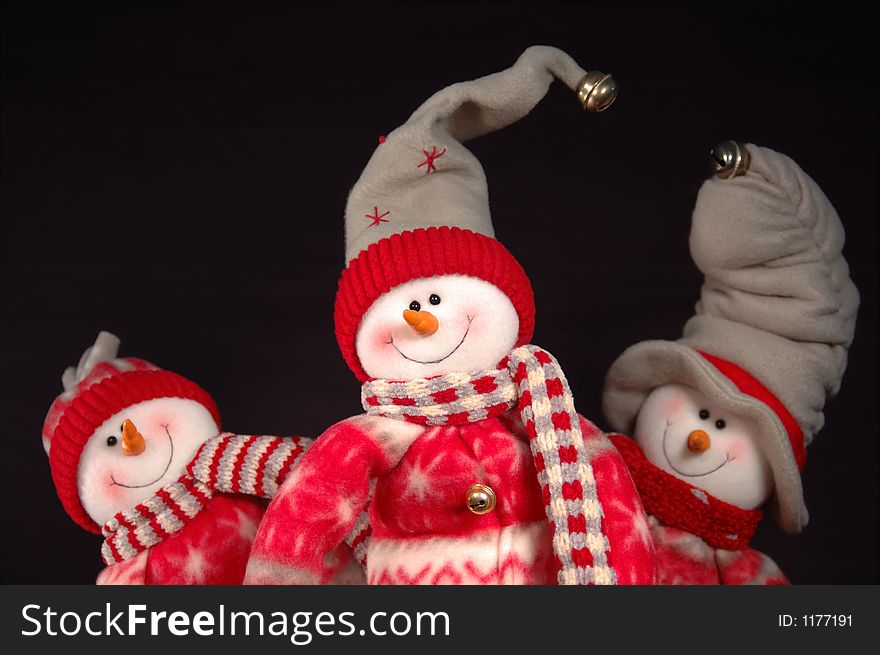 Three snowpeople posing whimsically for the camera. Three snowpeople posing whimsically for the camera.