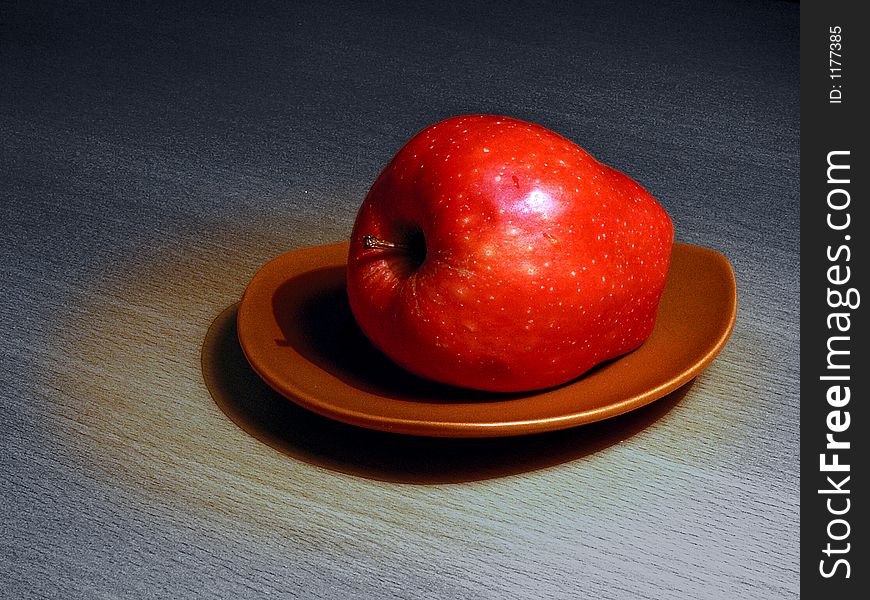 Red, ripe apple on a dish. Red, ripe apple on a dish